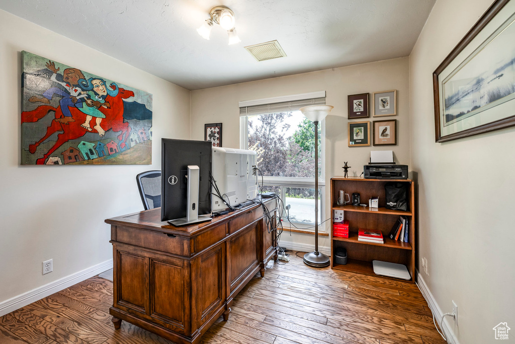 Home office featuring wood-type flooring and baseboards