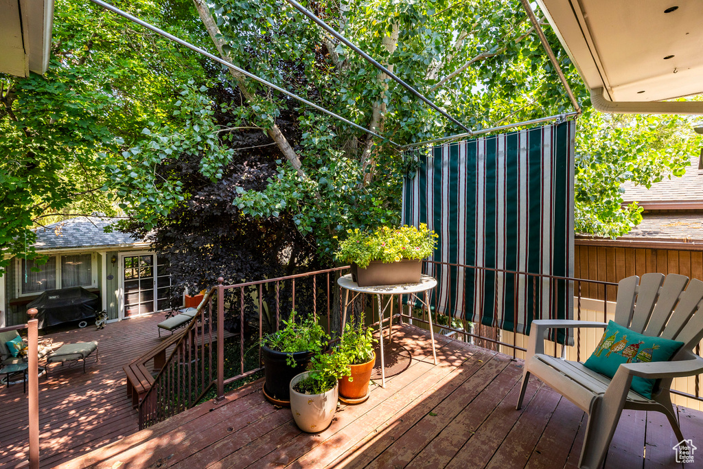 Wooden terrace featuring area for grilling