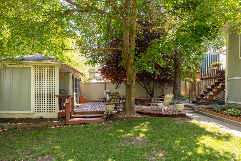 View of yard featuring a deck and stairs