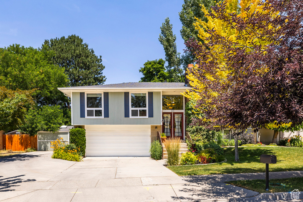 Split foyer home with french doors, driveway, and a garage