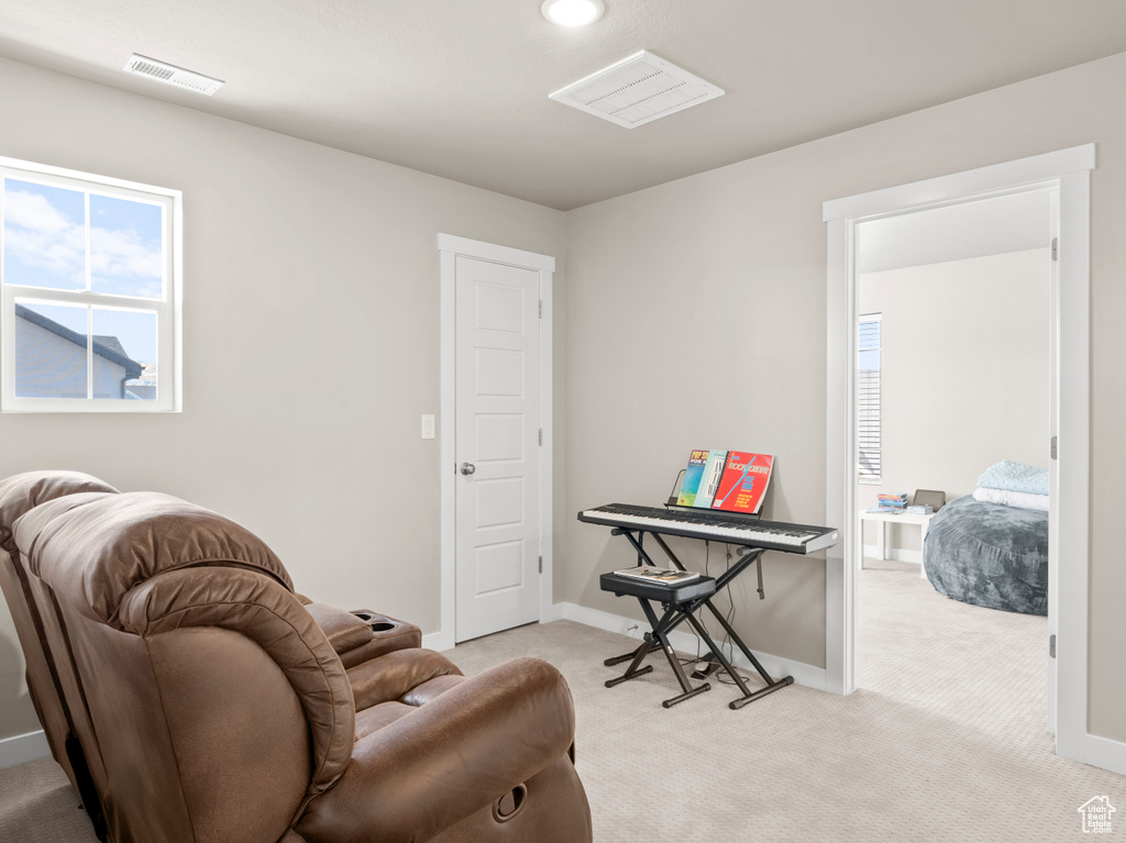 Sitting room featuring light carpet and recessed lighting