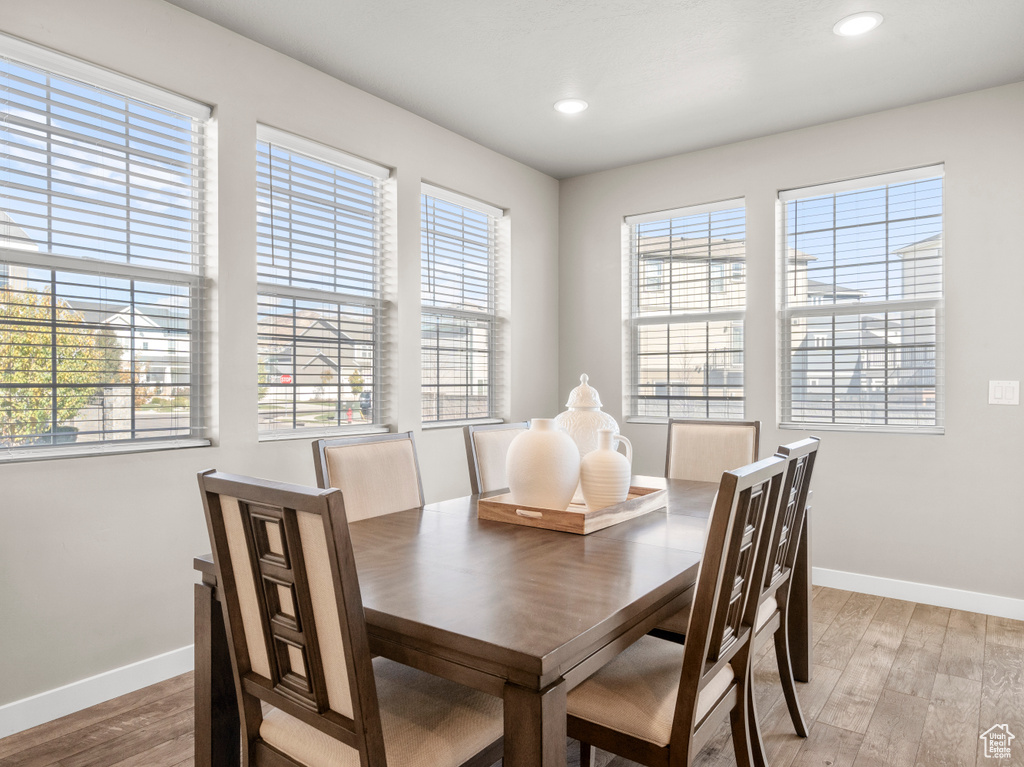 Dining area featuring light wood-style floors, plenty of natural light, and recessed lighting