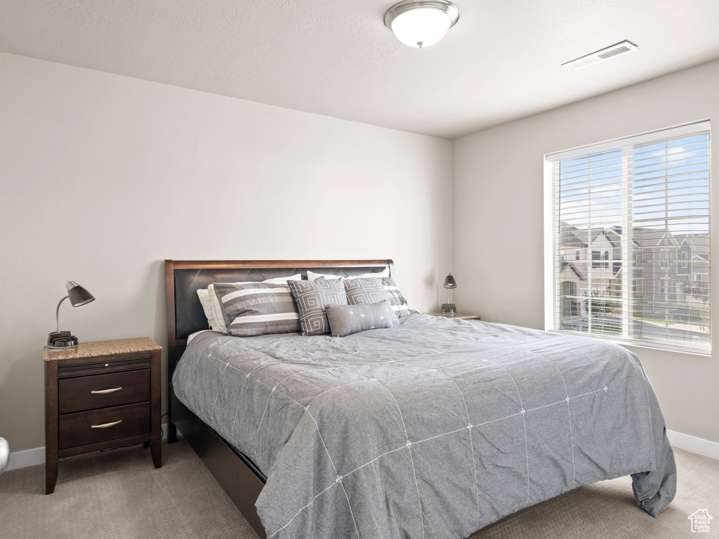 Carpeted bedroom with baseboards