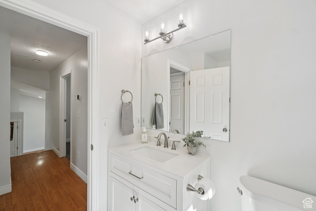 Bathroom featuring vanity and wood finished floors