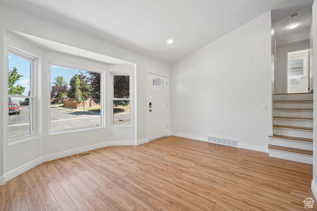 Entryway with light wood-style flooring, stairway, and recessed lighting