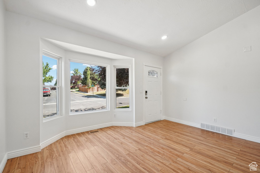 Spare room featuring light wood-style flooring and recessed lighting