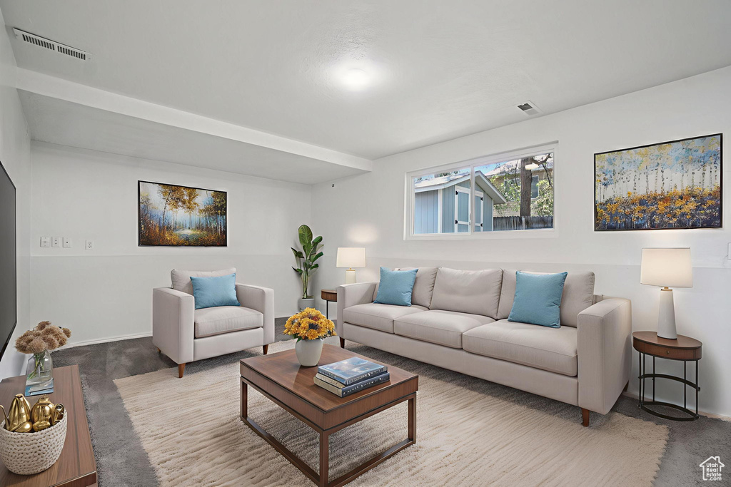 Carpeted living room featuring baseboards