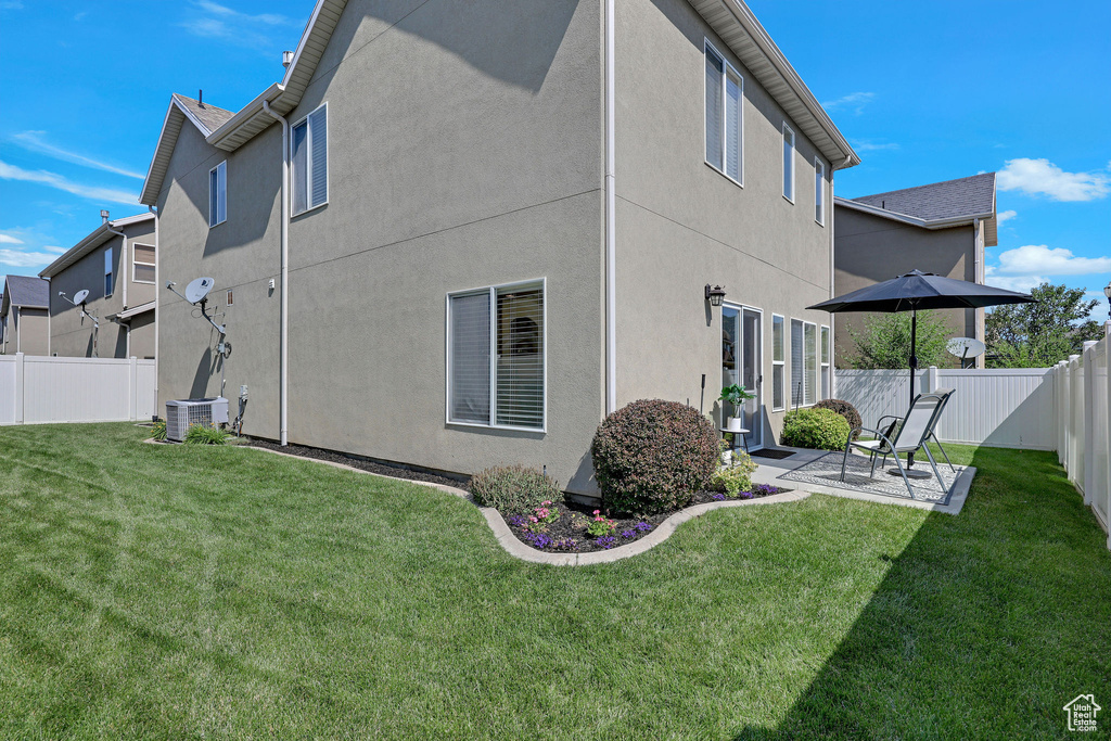 Back of property with a patio, a fenced backyard, and stucco siding
