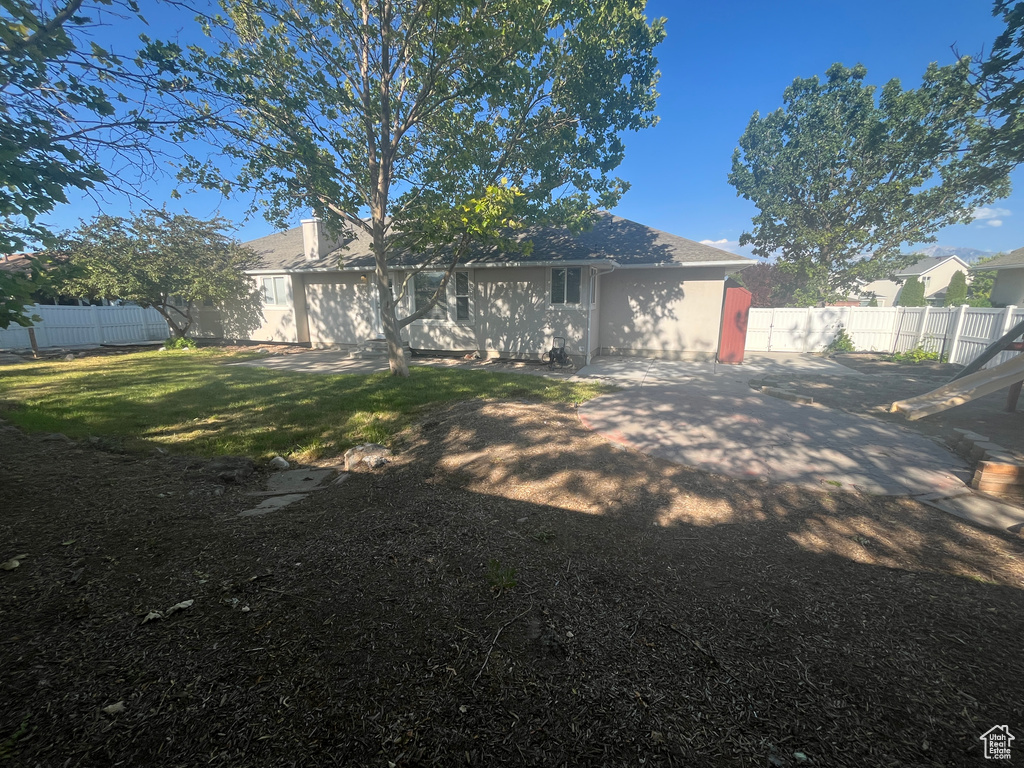 Rear view of property with a fenced backyard