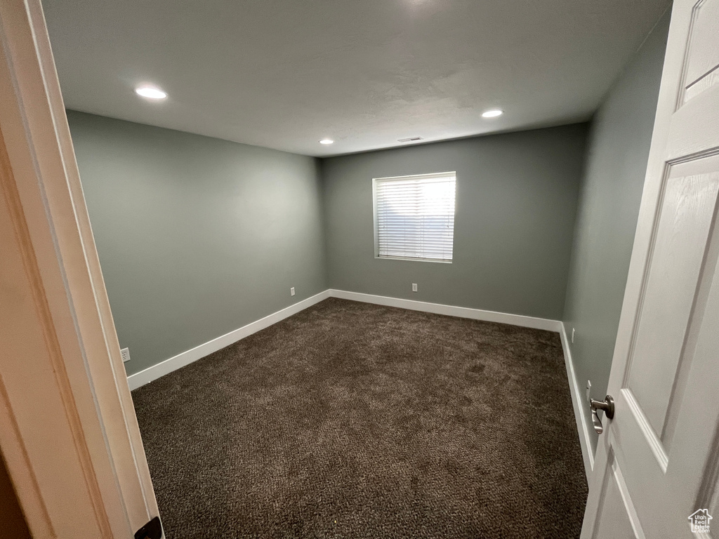 Unfurnished room featuring dark carpet and recessed lighting