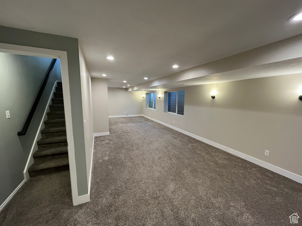 Finished basement with carpet floors, recessed lighting, and stairs