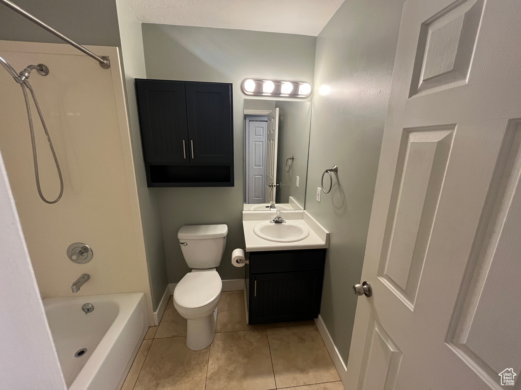 Bathroom featuring vanity, washtub / shower combination, and tile patterned floors
