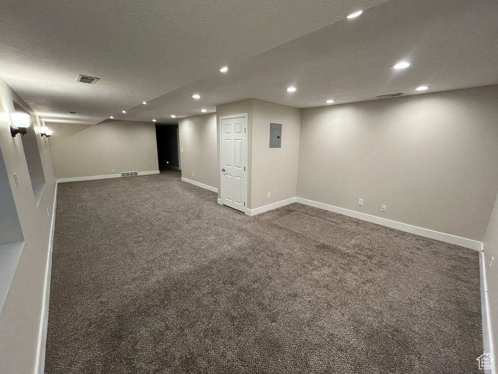Finished basement with recessed lighting and carpet