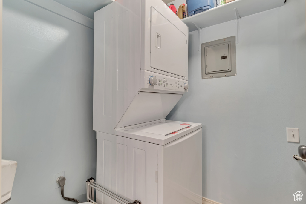 Washroom with stacked washer and clothes dryer