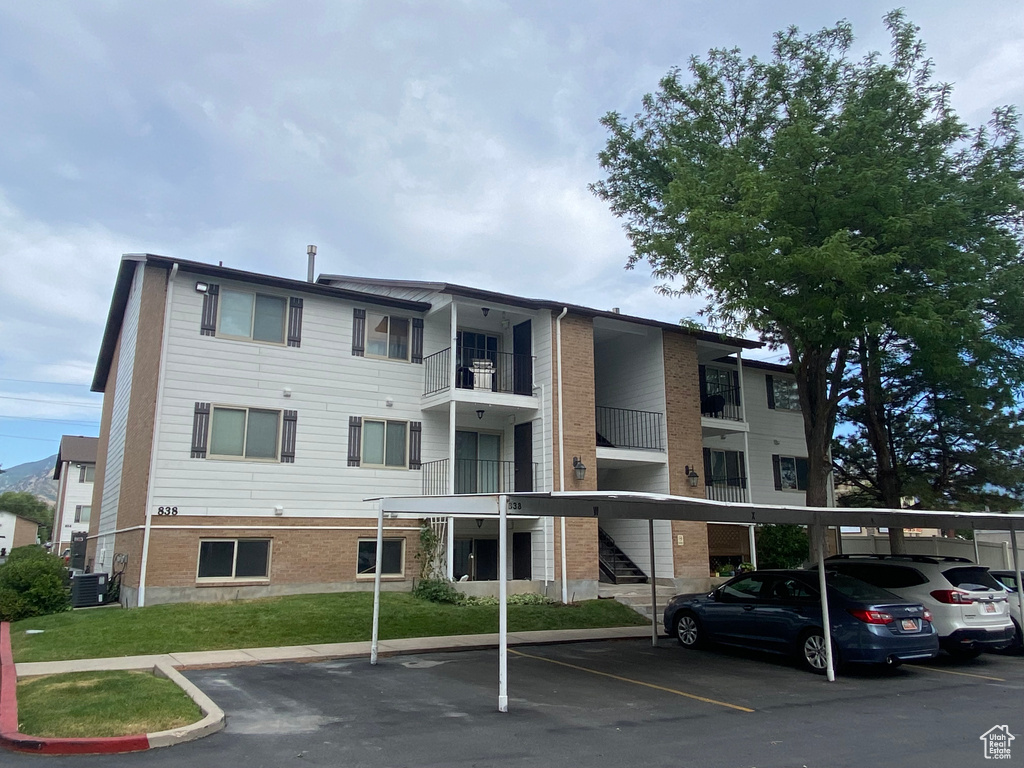 View of building exterior with covered parking