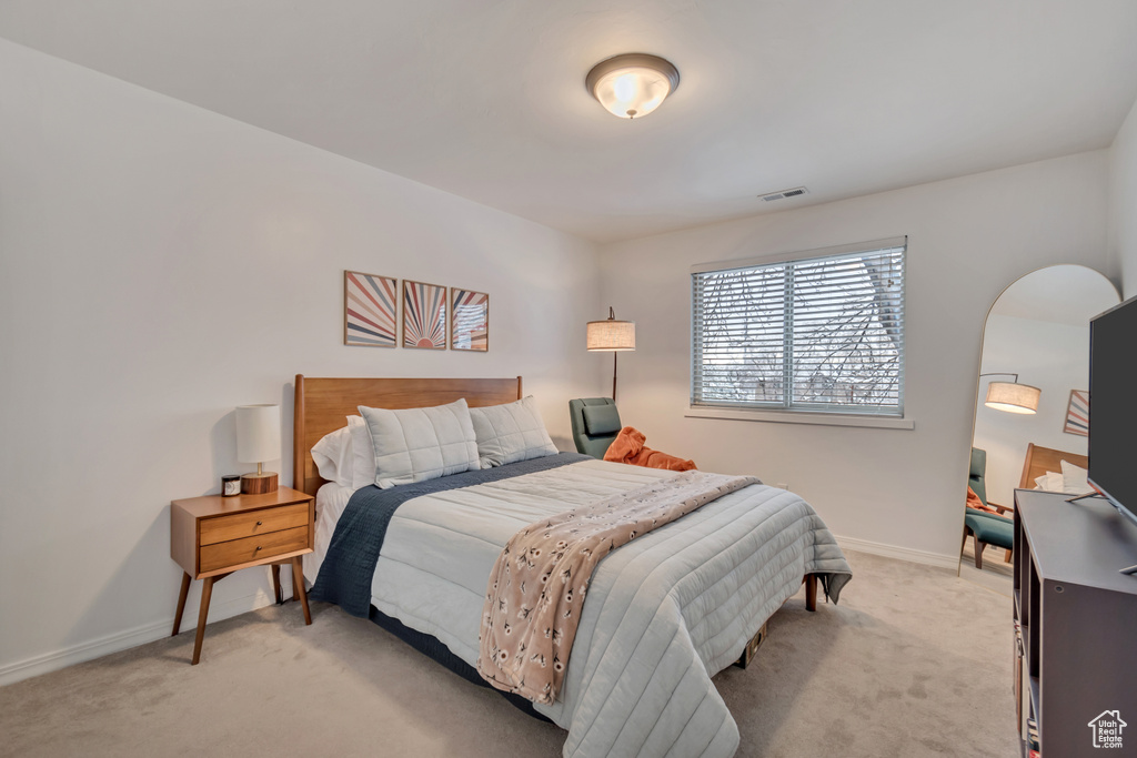 Bedroom with light carpet and baseboards