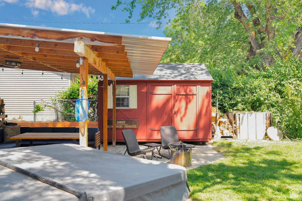 View of patio with a shed