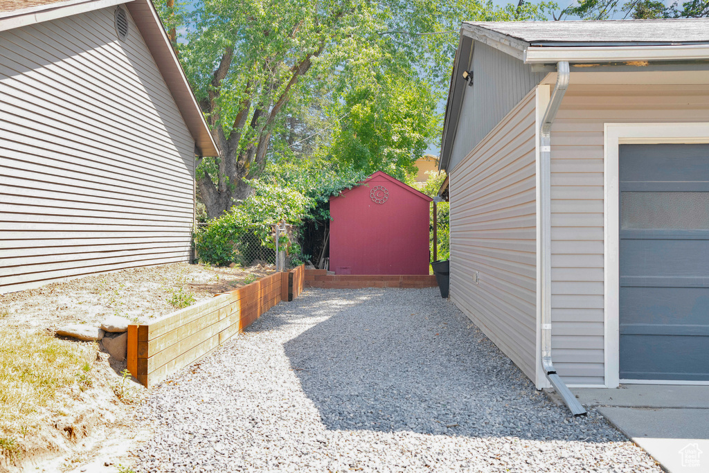View of property exterior featuring a shed