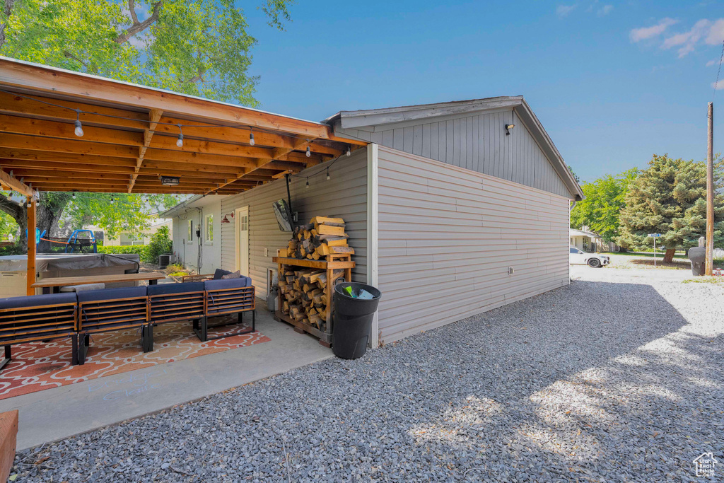 View of side of home with an outdoor hangout area and a patio