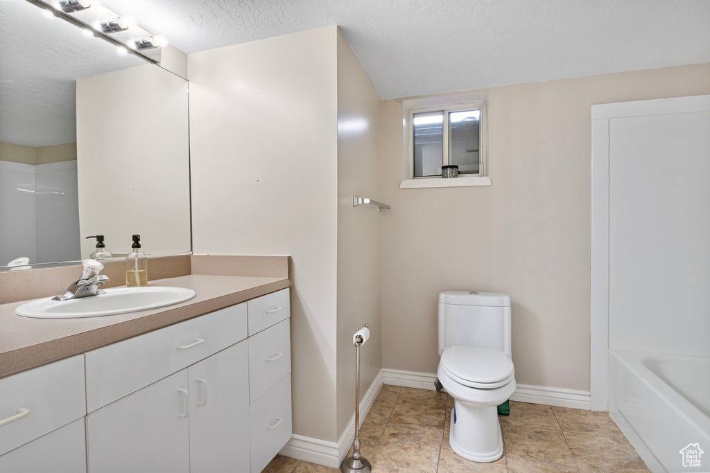 Bathroom featuring vanity and a textured ceiling