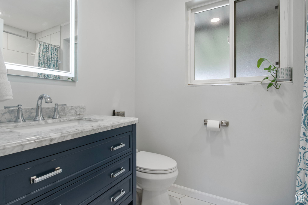 Full bath featuring vanity, tile patterned floors, and a shower with curtain