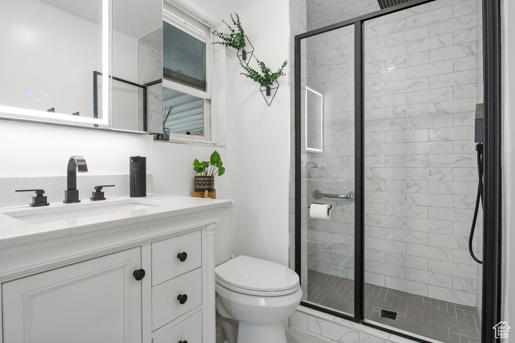 Bathroom featuring vanity and a shower stall