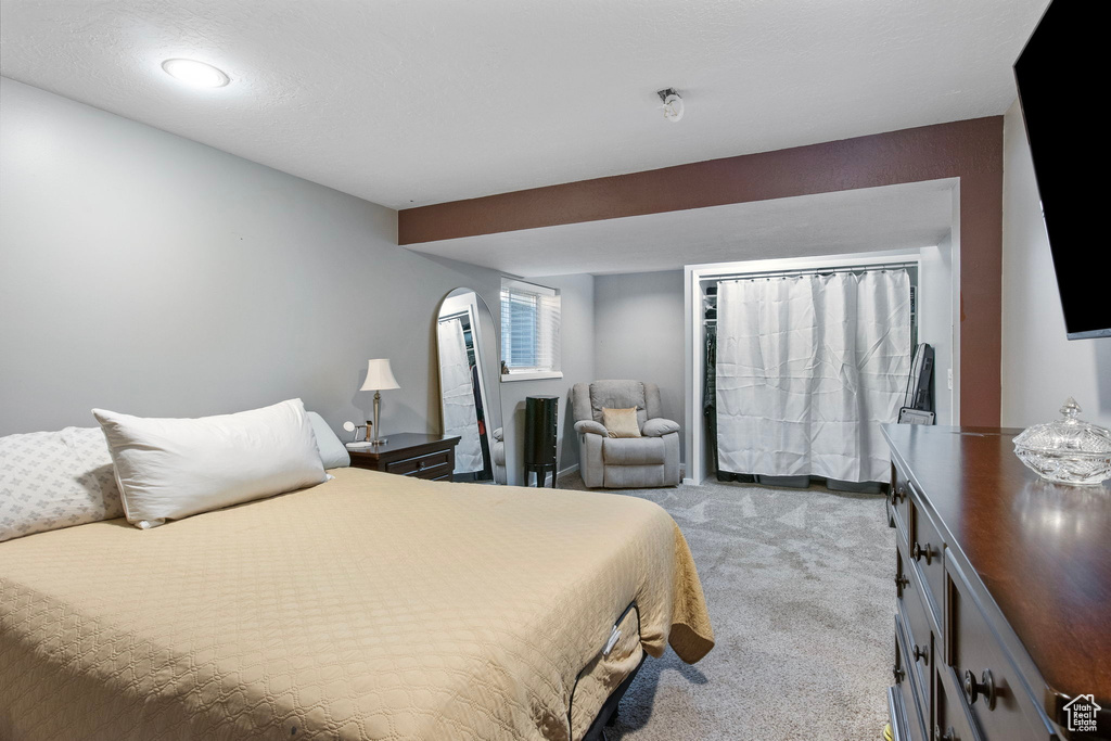 Bedroom featuring light carpet