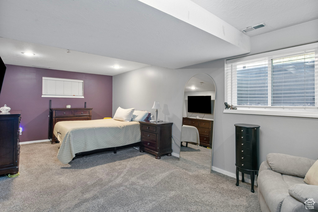 Carpeted bedroom featuring baseboards