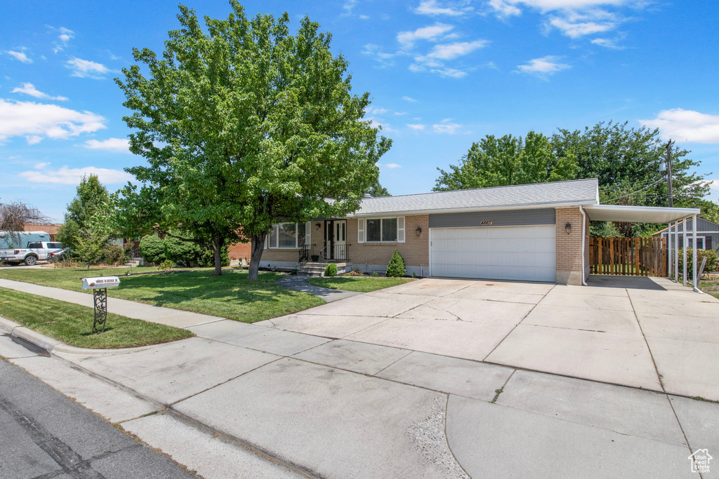 View of front of house with brick siding, an attached garage, and concrete driveway