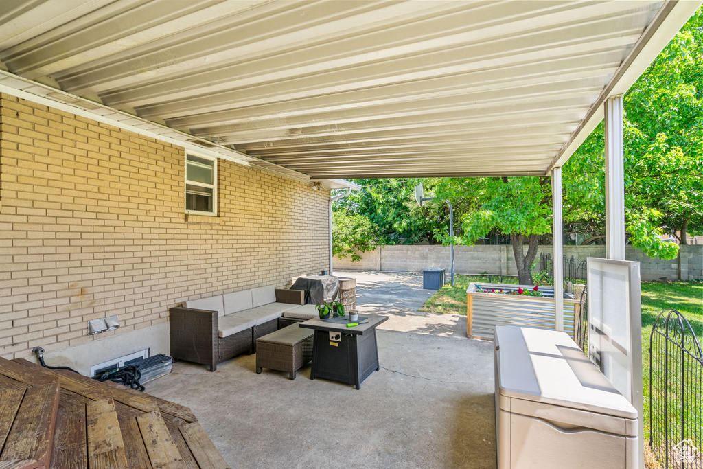Fenced backyard with outdoor lounge area and a patio