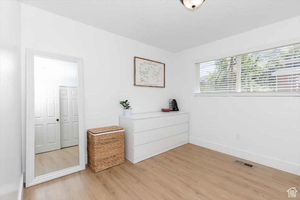 Bedroom with light wood finished floors and baseboards