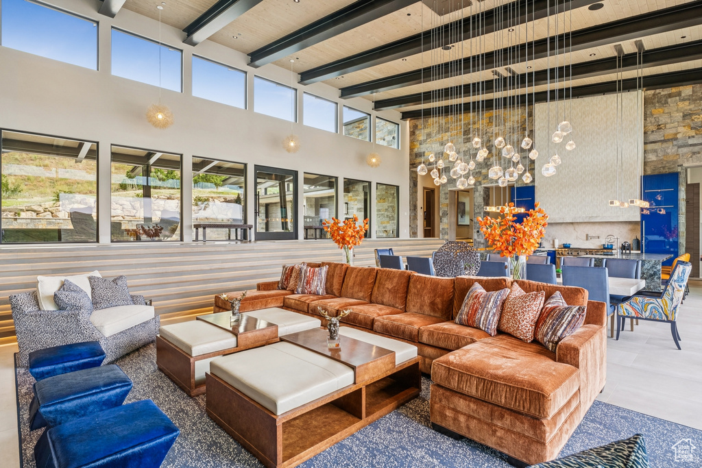 Living area with a high ceiling and a wooden ceiling with exposed beams