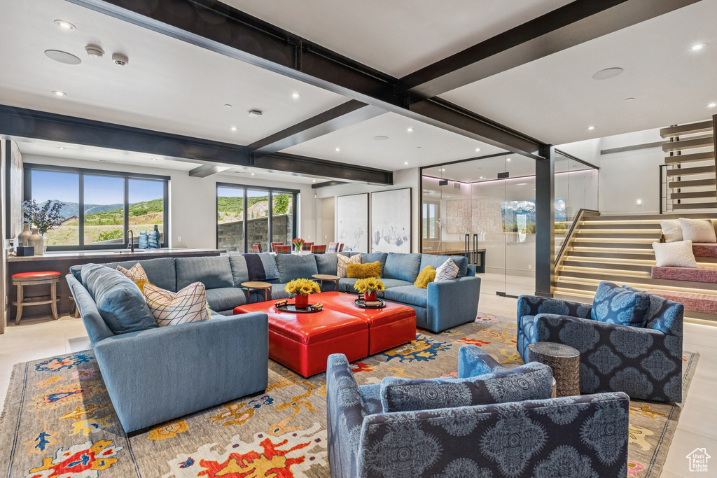 Common area featuring stairs, beamed ceiling, and recessed lighting