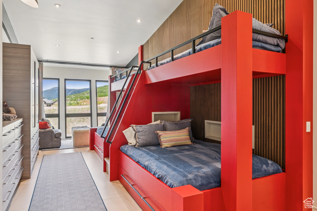 Bedroom with light tile patterned floors, a mountain view, recessed lighting, and access to exterior