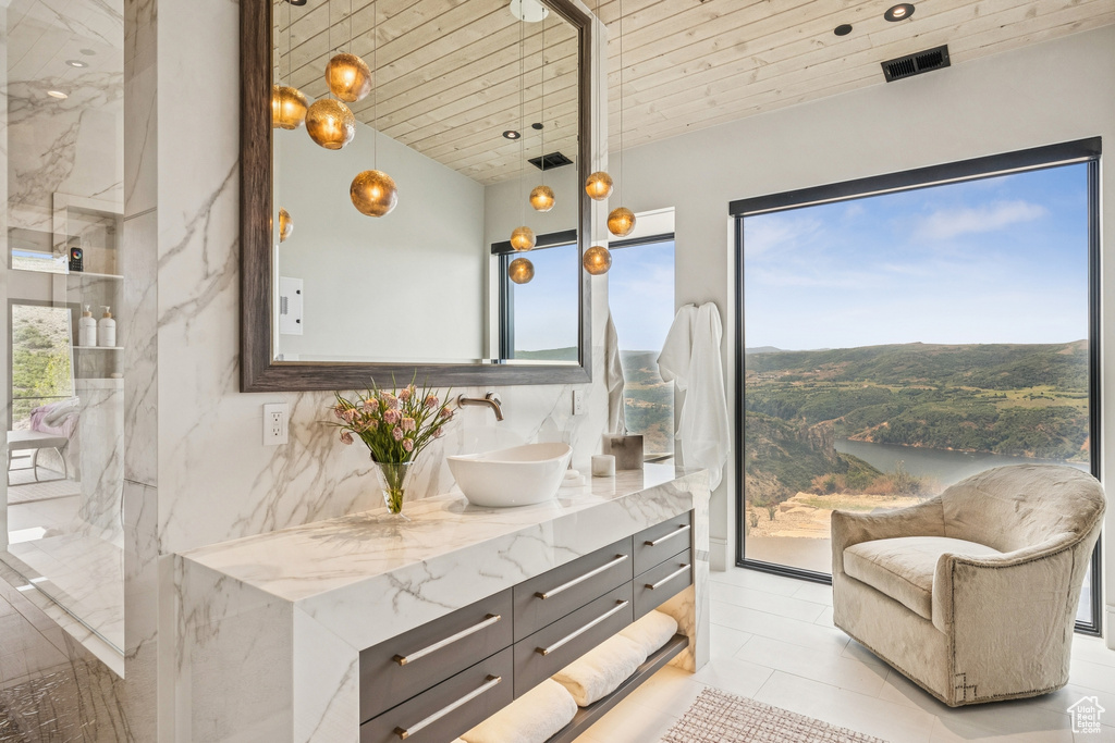 Full bath featuring vanity and plenty of natural light