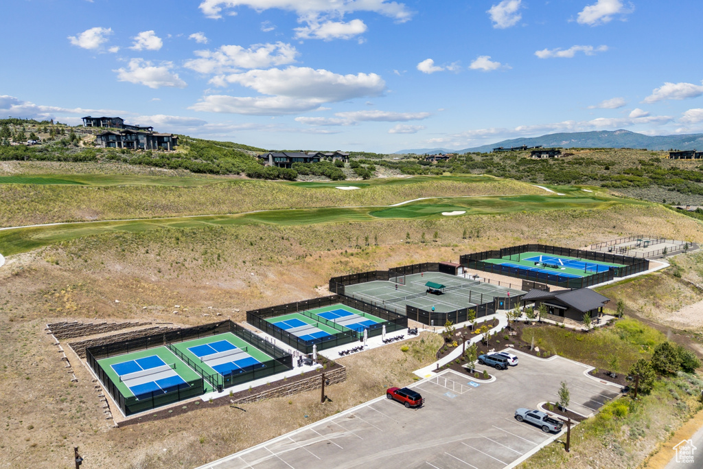 Drone / aerial view of a golf club and a mountain backdrop