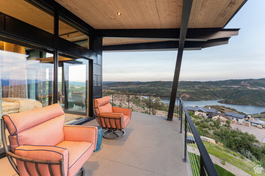 Patio / terrace featuring a water and mountain view
