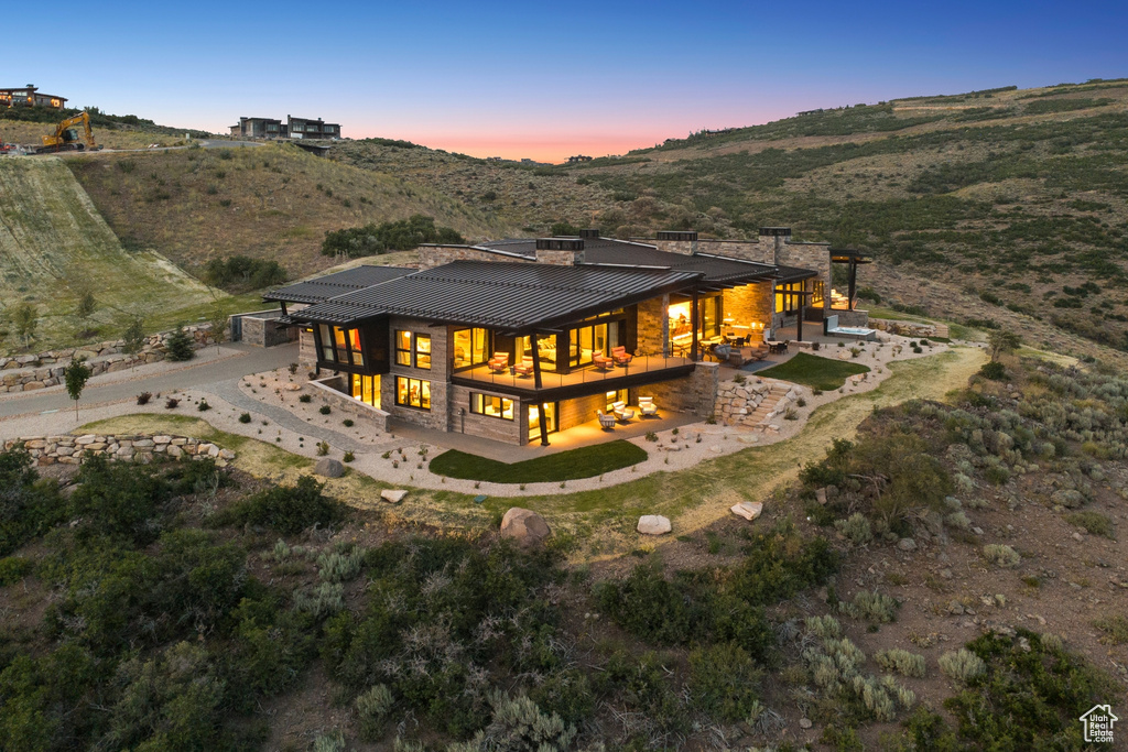Back of property featuring a patio area, a standing seam roof, a metal roof, and a mountain view