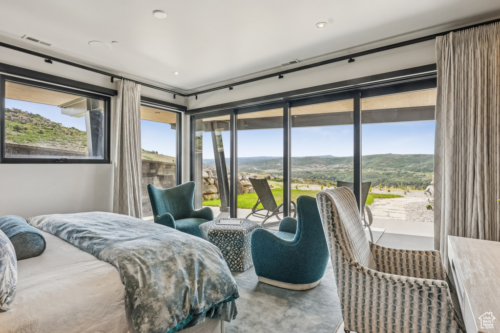 Bedroom featuring access to exterior and a mountain view