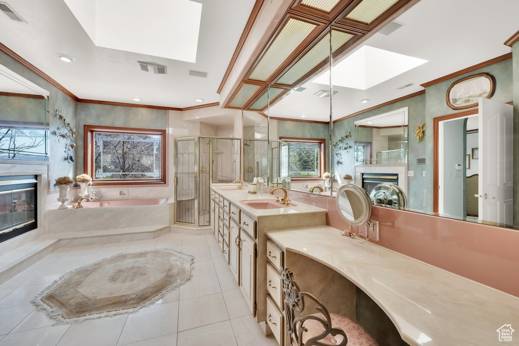 Bathroom with a glass covered fireplace, a skylight, a bath, a stall shower, and tile patterned floors