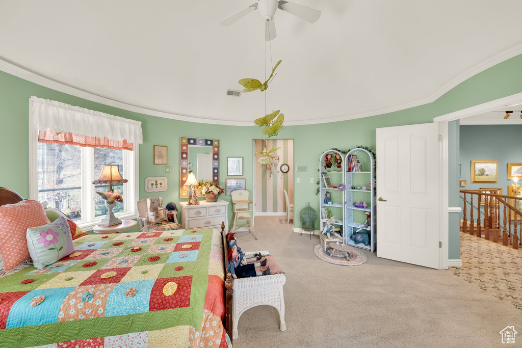Carpeted bedroom featuring ornamental molding and ceiling fan