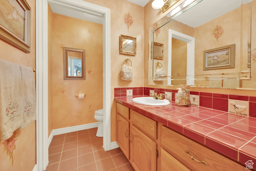 Bathroom with tile patterned flooring and vanity