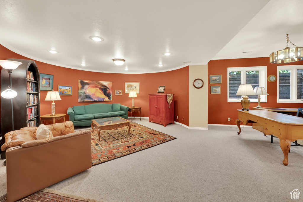 Living area featuring carpet flooring, ornamental molding, and recessed lighting