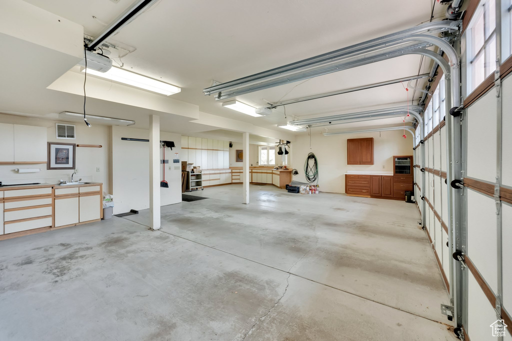 Garage featuring a sink and a garage door opener