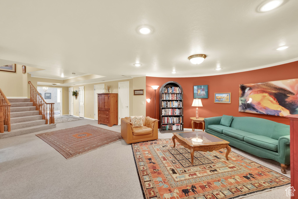 Living area featuring carpet, recessed lighting, stairs, and ornamental molding