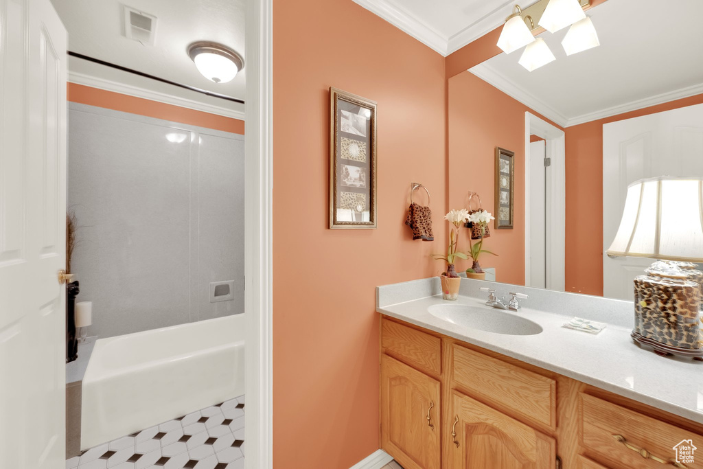 Full bathroom with vanity, ornamental molding, a skylight, and tub / shower combination
