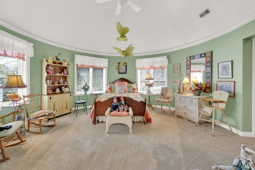 Bedroom with crown molding, carpet, and ceiling fan