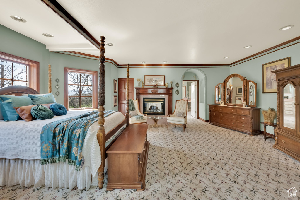 Bedroom with carpet flooring, a fireplace, ornamental molding, and recessed lighting