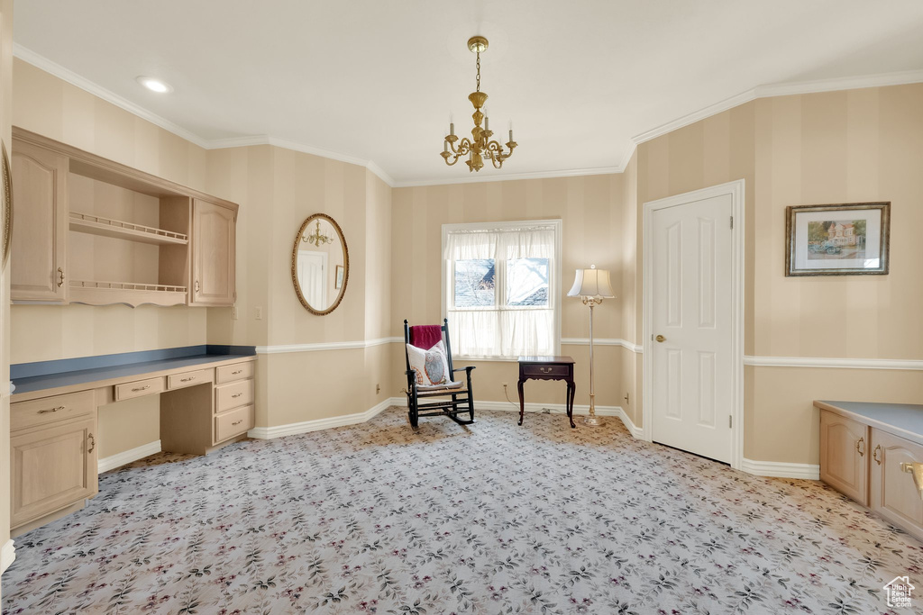 Living area featuring built in study area, ornamental molding, light carpet, and a chandelier