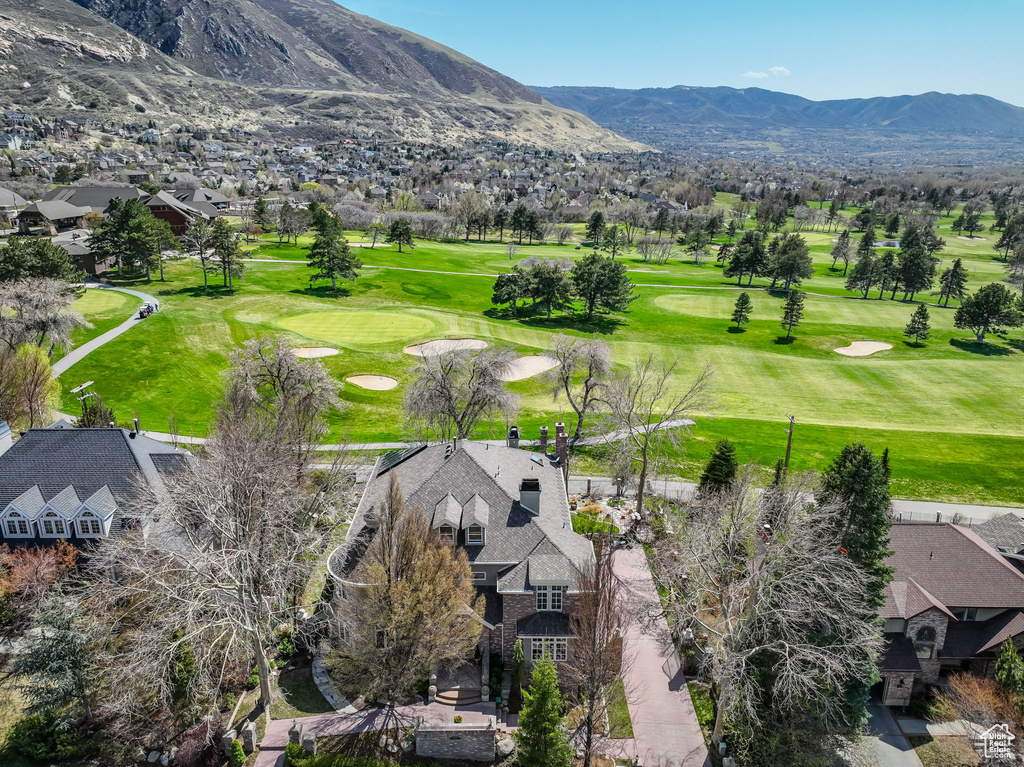 Aerial perspective of suburban area with a golf club and mountains